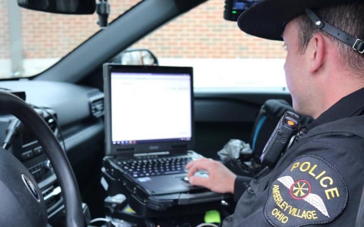 Patrol Officer reviews in-car computer