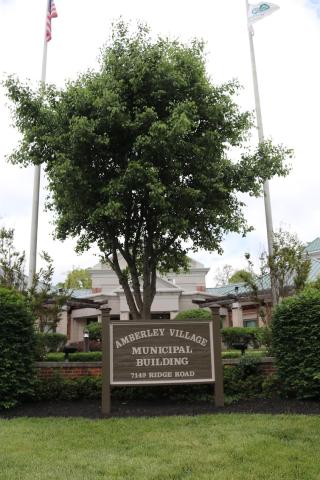 Amberley Village sign and a tree in front of the Municipal Building