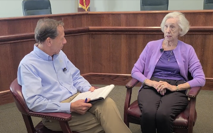 Resident Betty Whitaker being interviewed by Village Manager Scot Lahrmer